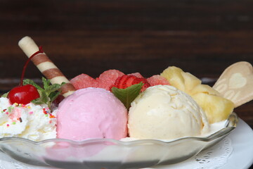 Fruit ice cream with fresh fruits, waffle and whipped cream