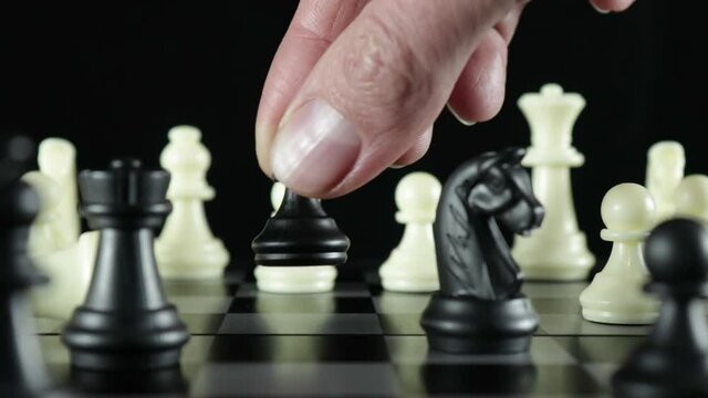 Black pawn cuts down white queen on chessboard