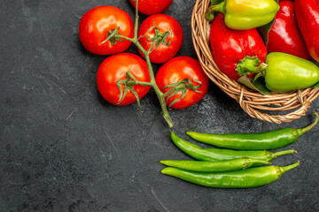 top view fresh bell-peppers with red tomatoes on a dark background food salad ripe photo