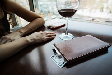 hundred dollars generous tip on the table in a leather folder. The girl drank the wine and paid the...