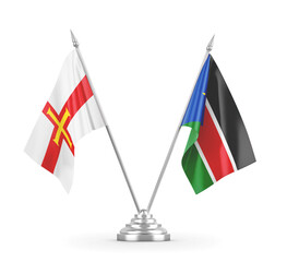 South Sudan and Guernsey table flags isolated on white 3D rendering