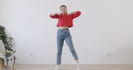 Mixed race girl recording trendy dance