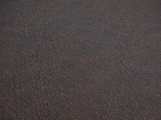 Rough black sand pattern on the beach