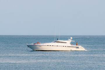 Fototapeta na wymiar Speed boat cruising in the sea. Young people relaxing in a sea
