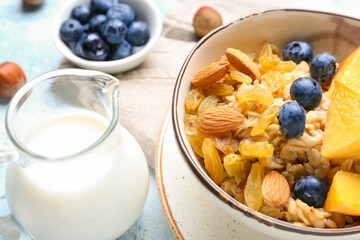 Bowl with tasty sweet oatmeal, closeup