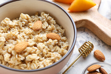 Bowl with tasty sweet oatmeal, closeup
