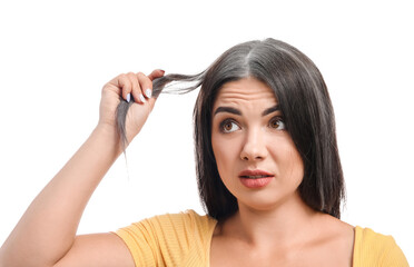 Fototapeta premium Stressed woman with graying hair on white background
