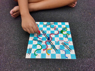 Boys playing snake and ladder game