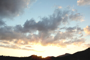 cloud and vanilla sky background with dark mountain silhouette