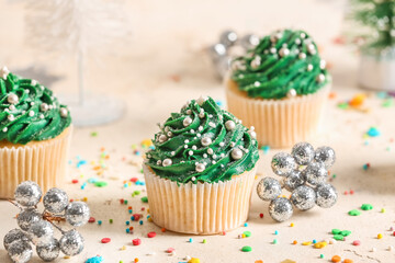 Tasty Christmas cupcakes on table