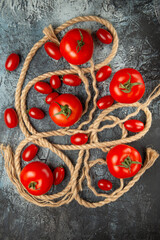 Fototapeta na wymiar top view fresh cherry tomatoes with ropes on dark background food ripe photo salad