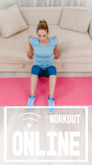 Healthy athletic girl using sofa while doing training at home, image with text workout online and oriented for use on a smartphone.