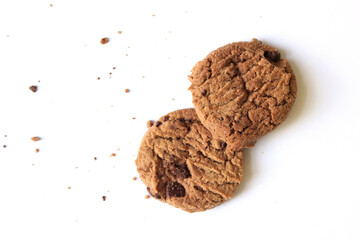 Chocolate chip cookies with crumbs isolated on white background