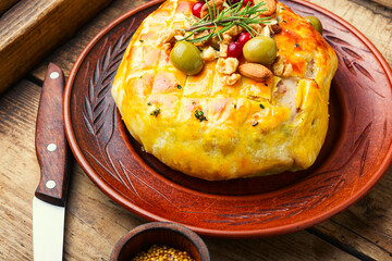 Camembert cheese baked in bacon