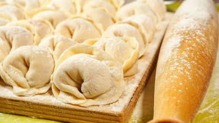 Meat Russian dumplings on a cutting board . The method of cooking the dumplings. Russian dumplings with meat. homemade ravioli. photo