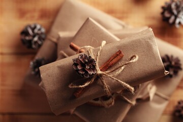 Gifts for Christmas and New Year. packed craft gifts with cinnamon and orange for decoration.