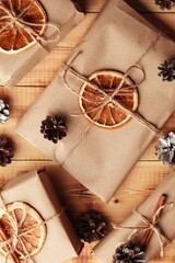 Gifts for Christmas and New Year. packed craft gifts with cinnamon and orange for decoration.
