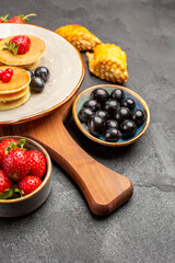 front view delicious pancakes with fruits on dark background cake fruit sweet pie