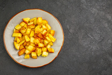top view delicious fried potatoes inside plate on dark background oil french fries food dinner photo color free space