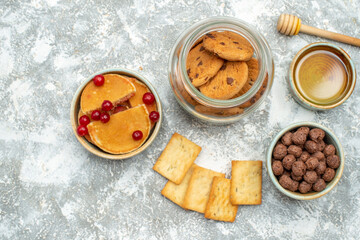 Fototapeta na wymiar Homemade cakes and chocolate biscuits in a glass jar on blue background