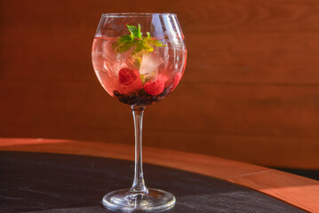 Raspberry Cocktail with ice and berry. Refreshing cocktail with berries inside. Delicious alcohol drink.