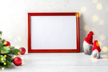 Christmas or New Year composition with gnomes (elf), decorations, wood sign mockup frame on white rustic wooden background. Festive, winter, concept.