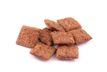 chocolate pillows for breakfast isolated on white background. Brown choco cereal pads with cream