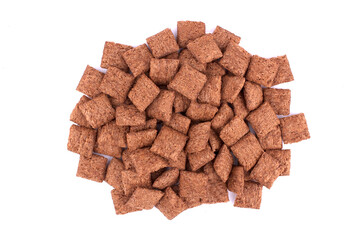 chocolate pillows for breakfast isolated on white background. Brown choco cereal pads with cream