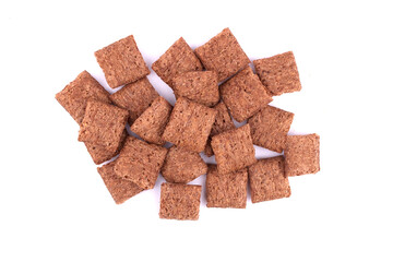 chocolate pillows for breakfast isolated on white background. Brown choco cereal pads with cream