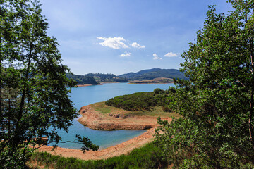 Amazing landscape of alpine lake with crystal clear blue water and perfect blue sky. Panoramic view of beautiful mountain landscape in National Park Of Sila, Calabria