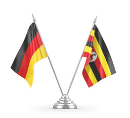 Uganda and Germany table flags isolated on white 3D rendering