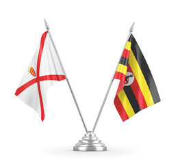 Uganda and Jersey table flags isolated on white 3D rendering