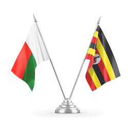 Uganda and Madagascar table flags isolated on white 3D rendering