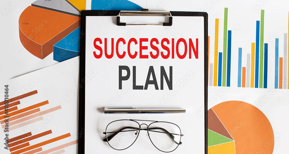 Aufkleber white sheet with the text of the succession plan on the background of documents and graphs.