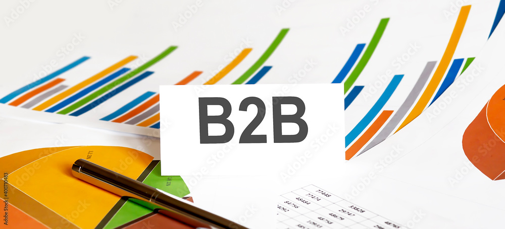 Poster b2b text on paper on chart background with pen