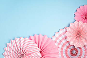 Festive party background with pink paper circle fans over pastel background. Festival, birthday, baby shower decoration