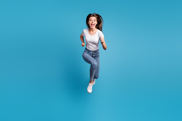 Fototapeta na wymiar Full body photo of pretty crazy girl run you jump up air unbelievable sale isolated on blue color background