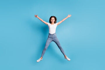 Fototapeta na wymiar Full size photo of happy woman jump up star shape weekend sale isolated on blue color background
