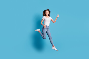 Fototapeta na wymiar Full body photo of funky young woman play imagine guitar jump air isolated on pastel blue color background
