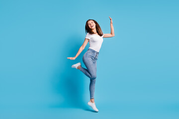 Fototapeta na wymiar Full body profile side photo of joyful woman enjoy dance jump look copyspace isolated on pastel blue color background