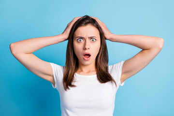 Fototapeta premium Photo of frightened sad young lady wear white clothes arms head isolated blue color background