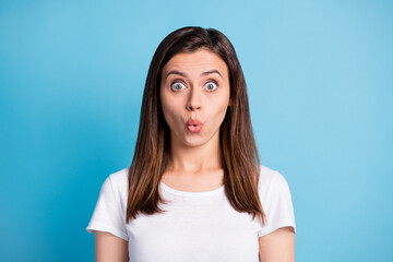 Fototapeta premium Photo of impressed frightened young lady wear white clothes big eyes lips pouted isolated blue color background