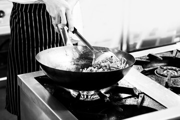 Chef cooking in a kitchen, chef at work, Black and White.