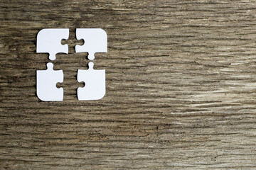 4 pieces of a puzzle do not fit together causing a difficult problem to solve. the white pieces are...