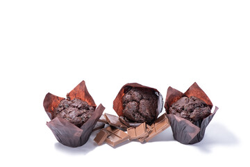 Delicious muffins with slices of chocolate isolated on white background