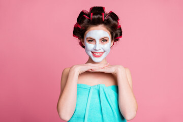 Portrait of pretty cheerful housewife wearing natural detox organic mask lifting flawless skin purifying isolated over pink color background