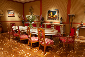 Showroom exhibited modern production furniture in classical period style arranged in a lavishly decorated interiors.