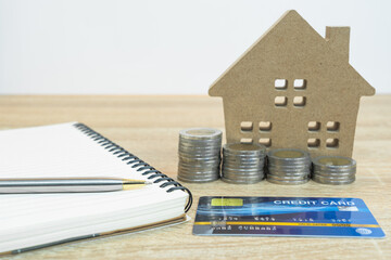 House model and credit card on table