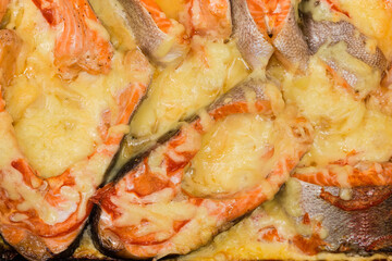 Trout steaks baked with cheese, top view, background