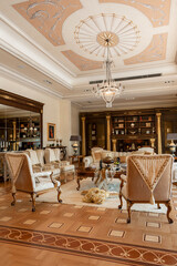 Showroom exhibited modern production furniture in classical period style arranged in a lavishly decorated interiors.